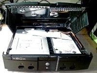 eX XboxOld CoverOff 01  Once the screws are removed from the underside of the Xbox, you can lift of the top panel/cover. (Sorry for crappy phone camera) to the left you can see the DVD drive and to the right we have a standard 3.5" Hard Drive.